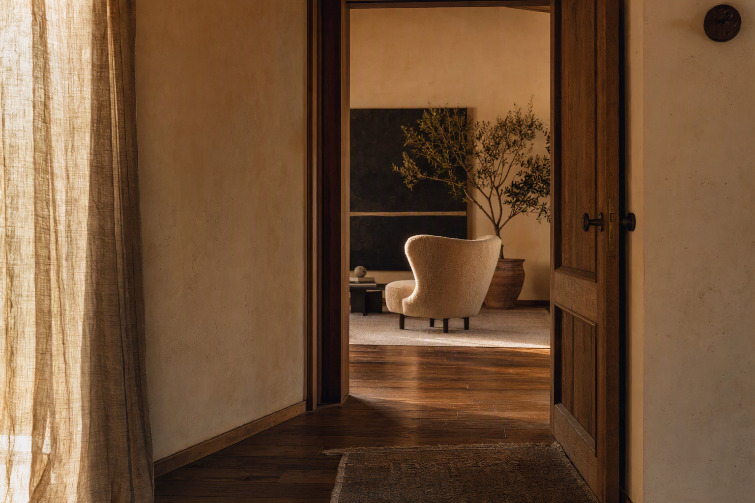Calm interior threshold framed by warm materials and gentle evening light