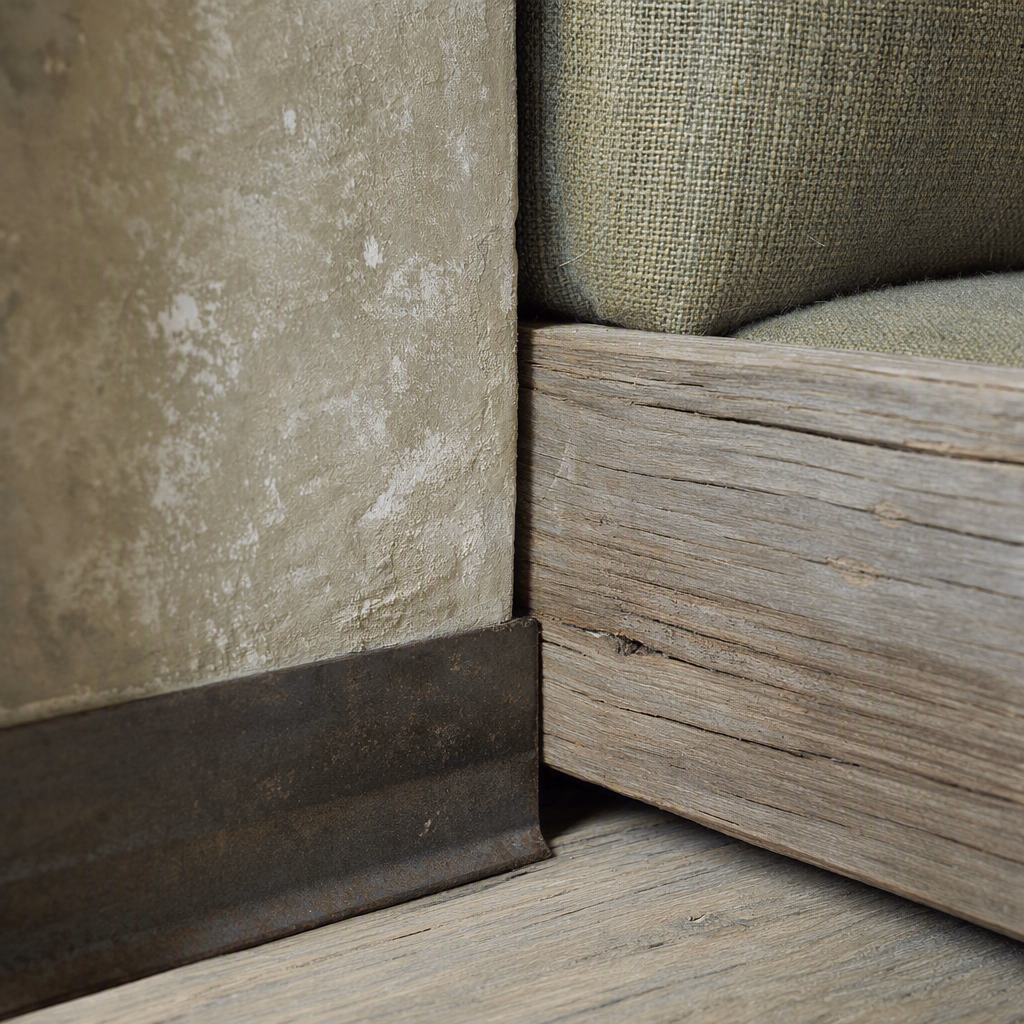 Close grouping of pale limewash, weathered oak, woven wool, and patinated metal