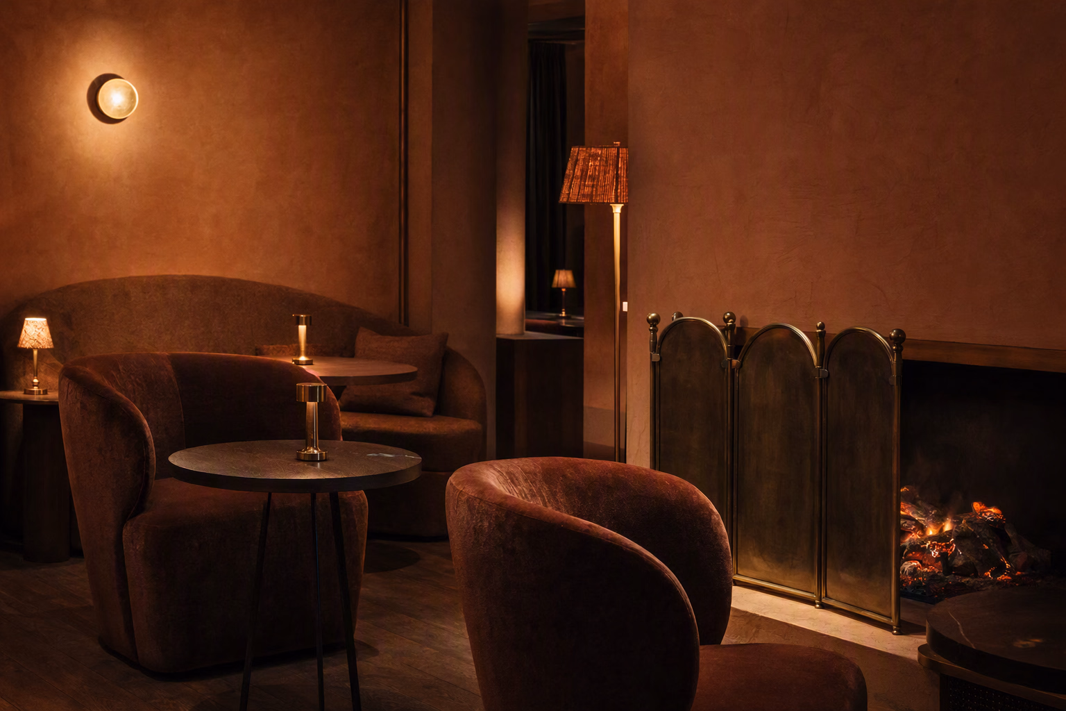 Flexible fireside lounge seating in mohair and dark oak under warm, low-level lighting